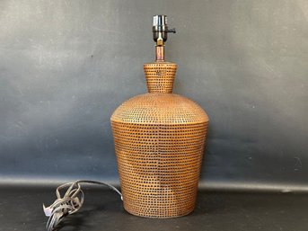 A Ceramic Table Lamp With A Hammered Copper Look