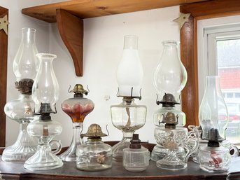 A Large Collection Of Antique Glass Oil Lamps