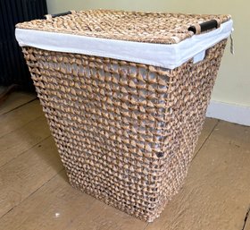 A Woven Hamper With Linen Lining