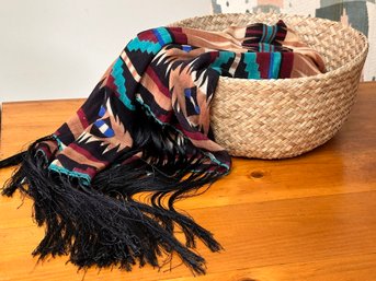 A Southwestern Throw Blanket In Woven Basket