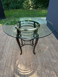 Glass Topped Round Table With Iron Base And Cabriole Legs