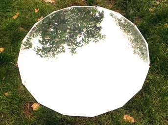 A Vintage Round Mirror With Angular Beveled Edges