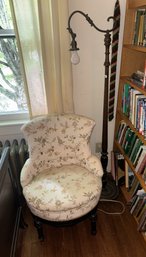 AN ANTIQUE BRIDGE LAMP AND A SLIPPER CHAIR