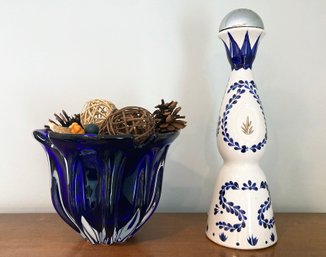 A Hand Blown Glass Vase And Ceramic Tequila Bottle