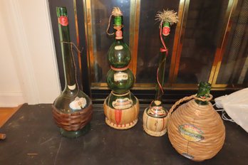 -Assortment Of Four Old Wine/chianti Bottles In Woven Holders:  Tallest Is 22.5