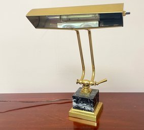 A Brass And Marble Piano Lamp