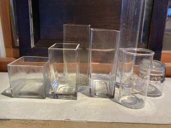 6 Glass Items A Jar With Lid And 5 Vases