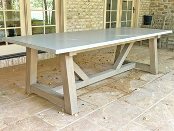 A Trestle Base Outdoor Dining Table With Poured Concrete Top By Restoration Hardware