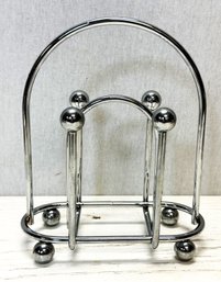 An MCM Metal Napkin Holder