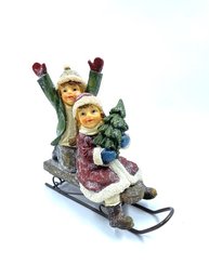 Two Children Riding Sled Figurine