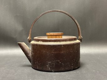 A Vintage Metal Teapot With Wood Lid