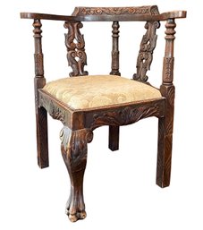 An Antique Oak Ornately Carved Corner Chair