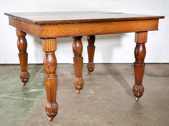 An Antique 19th Century Carved Oak Extendable Dining Table