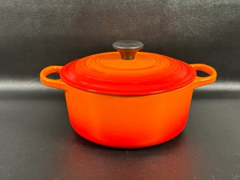 A Vintage Traditional Round Dutch Oven By LeCreuset In Flame