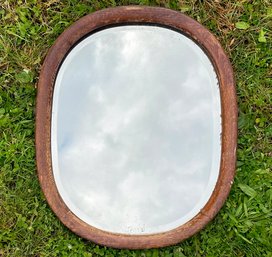 An Antique Oak Framed Beveled Mirror