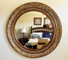 An Ornately Framed Round Mirror