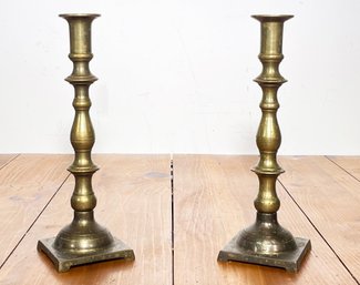 A Pair Of Antique Brass Candlesticks