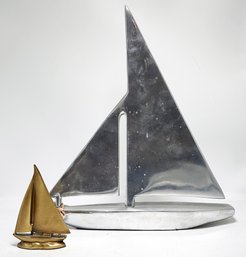 A Decorative Brass And Polished Alloy Sailboat Pairing By Zodax