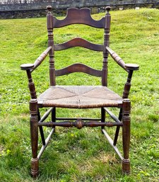 A 19th Century Turned Pine Rush Seated Ladder Back Arm Chair