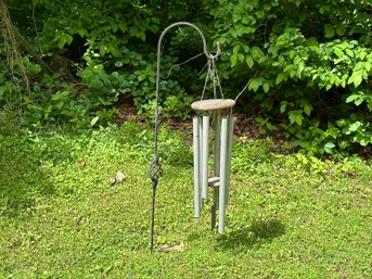 A Set Of Metal Pipe Windchimes On A Spiraled Shepherd's Hook