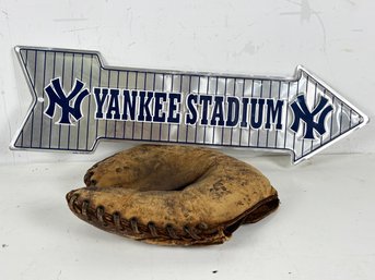 A Tin Yankee Stadium Sign And Vintage Baseball Glove