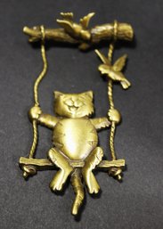 GOLD TONE CAT ON A SWING SIGNED 'JJ'