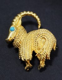 SIGNED 'DI NICOLA' GOLD TONE TURQUOISE EYE YAK BROOCH