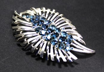 SIGNED TRIFARI RHODIUM PLATED BROOCH HAVING BLUE RHINESTONES