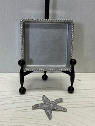 A Mariposa Cocktail Napkin Holder With Starfish Weight