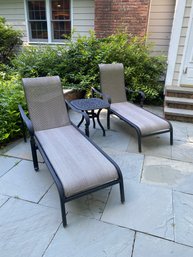 A Pair Of Cast Aluminum Chaise Lounge Chairs With Side Table.