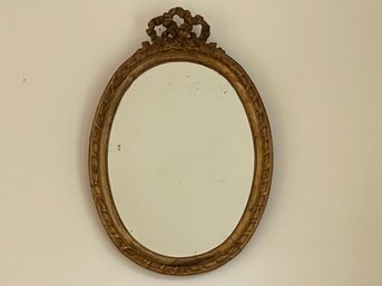 Antique Gilded Wall Mirror With Carved Bow Top Frame