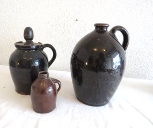 Black And Brown Stoneware Jugs, 1 With Wood Cover
