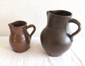 2 Stoneware Pitchers Black And Brown