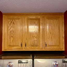 A Set Of  Honey Colored Oak Upper Cabinets - Laundry Room
