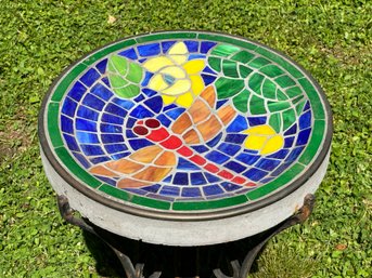 A Shallow Stained Glass Tile Birdbath On A Metal Stand