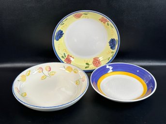 A Trio Of Large, Shallow Ceramic Bowls With Compatible Designs