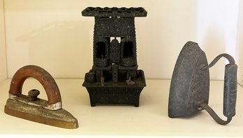 A Miniature Antique Cast Iron Oil Stove And Two Irons