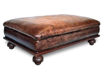 A Large Chestnut Leather Bun Footed Ottoman By Ralph Lauren