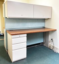 A Sleek Metal And Formica Desk With Storage Above And Pin Board Backer