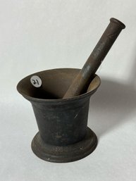 A CASTE IRON MORTAR AND PESTLE