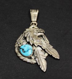 SIGNED 'JB' STERLING SILVER PENDANT HAVING EAGLE AND TURQUOISE STONE