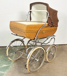 A Vintage Wicker Baby Carriage By Peg Perego