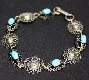 FINE STERLING SILVER AND TURQUOISE LINK BRACELET HAVING ROSETTES