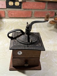 AN ANTIQUE COFFEE GRINDER