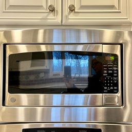 A GE Microwave With Stainless Steel Suround