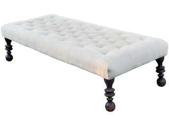 A Large Tufted Ottoman Or Coffee Table With Turned Mahogany Legs In Grey Linen