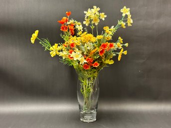 A Pretty Arrangement Of Faux Floral In A Glass Vase