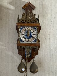 AN ORNATE DELFT PORCELAIN, BRONZE, AND WOOD WALL CLOCK