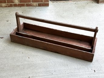 A Vintage Carry-All Bin In Wood With A Top Handle