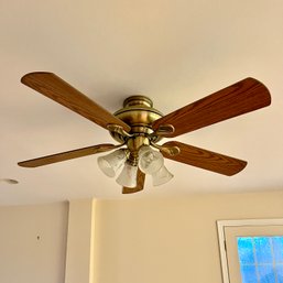 A Hampton Bay Wood Paddle Ceiling Fan With Lights